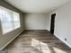 Bright living room with wood-look floors and neutral walls with lots of natural light at 422 Windsor Dr, Forest Park, GA 30297