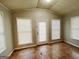 Bright sun room featuring tile floors, multiple windows, and a door to the outside at 422 Windsor Dr, Forest Park, GA 30297