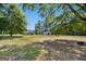 Expansive backyard featuring mature trees, a tire swing, and a large grassy area at 950 Old Jackson Rd, Locust Grove, GA 30248