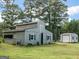 Exterior view of a weathered barn with a metal storage shed nearby at 950 Old Jackson Rd, Locust Grove, GA 30248