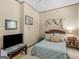 Bedroom featuring tan walls, white carpet, small windows, and a bed with blue and white bedding at 950 Old Jackson Rd, Locust Grove, GA 30248