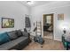 Cozy room with gray couch and exercise bike; a glimpse of a small room at 950 Old Jackson Rd, Locust Grove, GA 30248