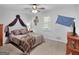 This bedroom is staged with a draped canopy, comfortable neutral color scheme, and a matching throw blanket at 950 Old Jackson Rd, Locust Grove, GA 30248