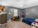 The gray bedroom includes a ceiling fan, a small work desk, a dark wood dresser and light vinyl floors at 950 Old Jackson Rd, Locust Grove, GA 30248