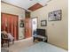 Bedroom featuring tan walls, white carpet, a wood closet door and a small television on a decorative stand at 950 Old Jackson Rd, Locust Grove, GA 30248