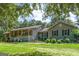 Charming single-story home with a inviting porch, lush landscaping, and classic details at 950 Old Jackson Rd, Locust Grove, GA 30248