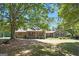 Ranch style house with large front trees providing shade, a large yard, and a front porch with seating at 950 Old Jackson Rd, Locust Grove, GA 30248