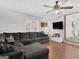 Inviting living room featuring a large sectional sofa, ceiling fan, and bright natural light at 950 Old Jackson Rd, Locust Grove, GA 30248