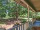 Inviting back porch with a view of a wide open green yard and mature shade trees at 950 Old Jackson Rd, Locust Grove, GA 30248