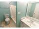 Clean bathroom with a bathtub, toilet and vanity at 218 Groveland Dr, Peachtree City, GA 30269