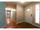 Bright hallway with wood floors and access to bathroom and bedrooms at 218 Groveland Dr, Peachtree City, GA 30269