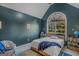 Serene bedroom with dark-teal walls and an arched window at 1000 Maria Dr, Mcdonough, GA 30253