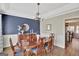 Formal dining room with a large table, chandelier, and built-in hutch at 102 Morallion Hls, Peachtree City, GA 30269