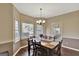 Charming dining room with bay window and wood table at 102 Morallion Hls, Peachtree City, GA 30269