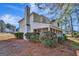 Side view of a two-story home with white siding and screened porch at 102 Morallion Hls, Peachtree City, GA 30269