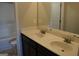 Bathroom with double sinks, dark cabinets, and a mirror with great lighting at 12226 Flannery Ln, Hampton, GA 30228