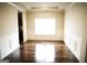 Dining room with wood floors, modern molding, and a large window at 12226 Flannery Ln, Hampton, GA 30228