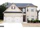 Charming two-story brick home with a two-car garage and manicured landscaping at 12226 Flannery Ln, Hampton, GA 30228