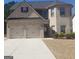 Charming two-story brick home with a two-car garage and manicured landscaping at 12226 Flannery Ln, Hampton, GA 30228