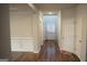 Inviting hallway with wood floors, neutral paint, and access to multiple rooms at 12226 Flannery Ln, Hampton, GA 30228