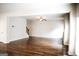 Open concept living room with wood floors, neutral paint, fireplace, and staircase at 12226 Flannery Ln, Hampton, GA 30228