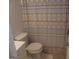 Cozy bathroom showcases a toilet with a patterned shower curtain at 3248 Brisbane Way, Lithonia, GA 30038