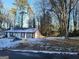 Ranch style home with snow covered yard and trees at 3248 Brisbane Way, Lithonia, GA 30038