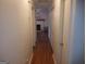 Hallway with wood floors leads into a living room featuring a fireplace at 3248 Brisbane Way, Lithonia, GA 30038