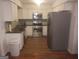 Well-lit kitchen with stainless steel appliances, white cabinetry, and granite countertops at 3248 Brisbane Way, Lithonia, GA 30038