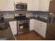 Kitchen featuring stainless steel appliances, white cabinets, and granite countertops at 3248 Brisbane Way, Lithonia, GA 30038