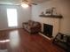 Bright living room featuring a decorative fireplace, wood flooring, and comfortable seating at 3248 Brisbane Way, Lithonia, GA 30038