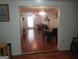 Open-concept living room with hardwood floors and a fireplace at 3248 Brisbane Way, Lithonia, GA 30038
