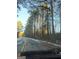 Road near property with tall trees at 3248 Brisbane Way, Lithonia, GA 30038