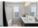 Clean bathroom with single vanity and bathtub at 553 Dasheill Ln, Atlanta, GA 30349