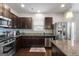 Modern kitchen with dark cabinets and stainless steel appliances at 553 Dasheill Ln, Atlanta, GA 30349