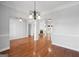 Open dining room with hardwood floors, chandelier, and view to Gathering room at 811 Somersby Dr, Dallas, GA 30157