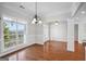 Bright dining room with hardwood floors, chandelier, and large windows at 811 Somersby Dr, Dallas, GA 30157