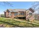 Two-story house back view, deck, and partial wooded view at 811 Somersby Dr, Dallas, GA 30157