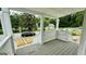 Relaxing front porch with white lattice details and steps leading to the yard at 1222 Bronx Nw St, Atlanta, GA 30314