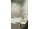 Modern shower with gray tile surround at 1222 Bronx Nw St, Atlanta, GA 30314