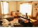 Living room with brown leather sectional sofa and wooden chairs at 561 Commercial Nw Ave, Atlanta, GA 30318
