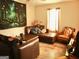 Living room with brown leather sectional and large tapestry at 561 Commercial Nw Ave, Atlanta, GA 30318