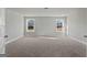 Spacious bedroom with neutral carpeting and natural light from two large windows at 172 Austin Dr, Mcdonough, GA 30252