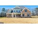 Two story house with brick and siding exterior, large windows and a grassy yard at 172 Austin Dr, Mcdonough, GA 30252