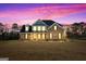 Stunning two story home with brick and siding exterior, illuminated at dusk at 172 Austin Dr, Mcdonough, GA 30252