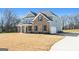 Two-story home with brick and siding, large yard, and a paved driveway at 172 Austin Dr, Mcdonough, GA 30252