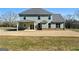 House back view showing a covered patio and large backyard at 172 Austin Dr, Mcdonough, GA 30252