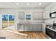 Modern kitchen features gray cabinets, granite countertops, and sliding glass doors leading to a patio at 172 Austin Dr, Mcdonough, GA 30252