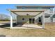 Covered patio with ceiling fan and concrete flooring adjacent to the house at 172 Austin Dr, Mcdonough, GA 30252