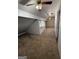 Well-lit attic with neutral carpet, bright window, and multiple ceiling fans at 97 Willowick Dr, Lithonia, GA 30038